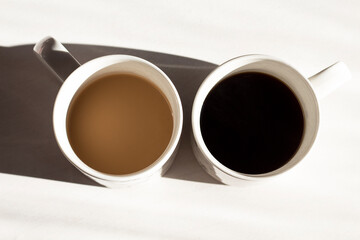 Two cups of freshly brewed coffee: with and without milk