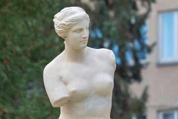 Antique sculptural composition with a woman and a column