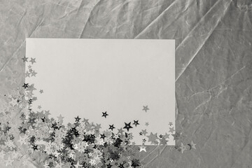 empty paper with silver shiny stars, monochrome colored