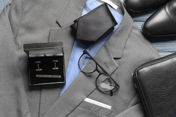 Set of stylish male accessories and clothes on wooden background