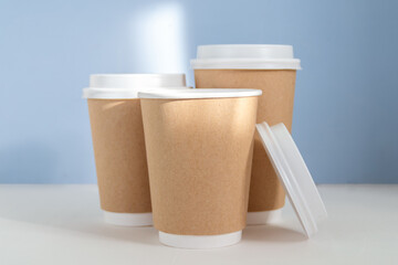 paper cup to go against light blue background