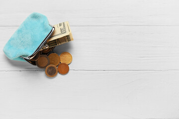 Blue wallet with money on white wooden background