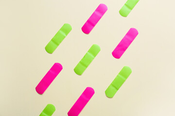 Different medical plasters on color background