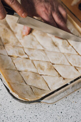 homemade diamond shape greek middle eastern baklava with almonds, cinnamon, sugar 