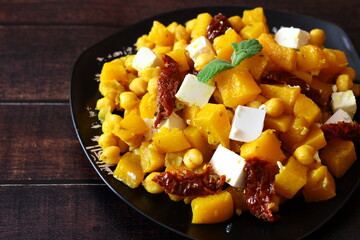 Roasted pumpkin and chickpeas salad with feta cheese and sun-dried tomatoes