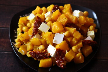 Roasted pumpkin and chickpeas salad with feta cheese and sun-dried tomatoes