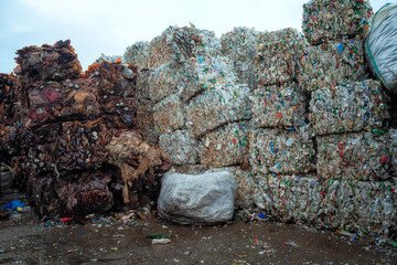 Bundle of pressed plastic bottles prepared for a garbage recycling on waste recycling plant. Camera moves forward. Pollution problem. Stabilized video