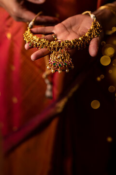 Woman holding an heirloom gold necklace 