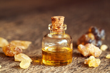 A bottle of aromatherapy essential oil with frankincense resin crystals
