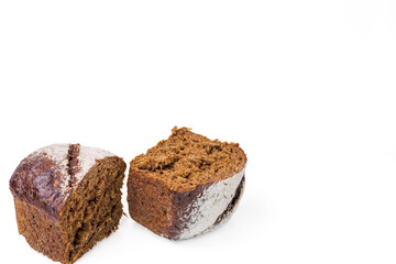 Close up view of cut dark loaf bread isolated on white background. 