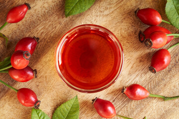 Rosehip seed oil in a glass bowl, top view