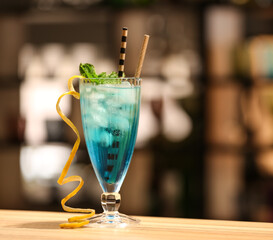 Glass of Blue Lagoon cocktail on table in bar