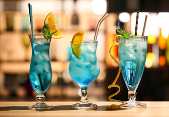 Glasses of Blue Lagoon cocktail on table in bar