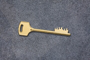 the old ornate golden decorative key, vintage design element on a desk