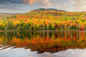 Mount Kaaikop in the background with Lac Legault showing the Autumn fall colors in the water reflection, Quebec, Canada. - 465405110