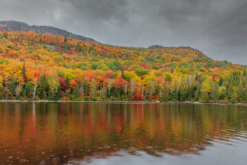 Mount Kaaikop in the background with Lac Legault showing the Autumn fall colors in the water reflection, Quebec, Canada. - 465405115