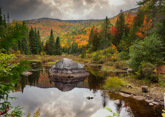 Mount Kaaikop in the background with Lac Legault showing the Autumn fall colors in the water reflection, Quebec, Canada. - 465405125