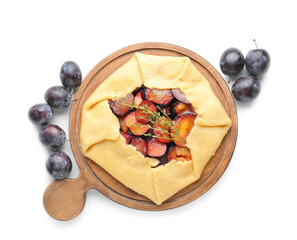 Board with tasty plum galette on white background
