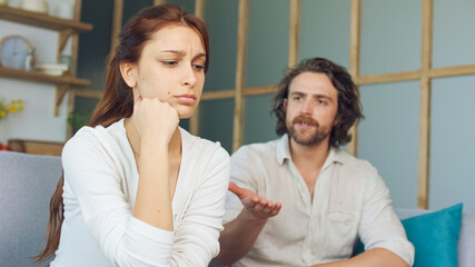 Couple Quarreling Sitting on the Couch at Home, Boyfriend Screams Accusing Girlfriend. Relationship...