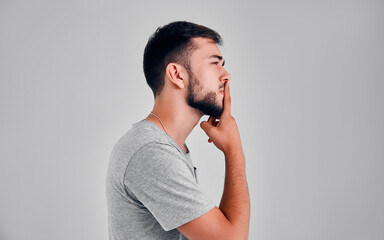 Young man in the studio on a gray background