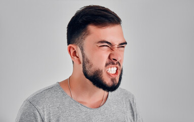 Young man in the studio on a gray background