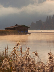 wooden boat on the lake on a misty morning
