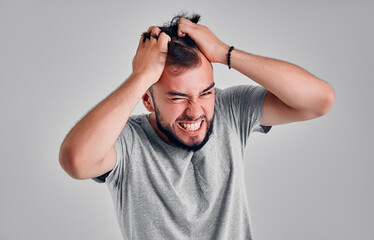 Young man in the studio on a gray background