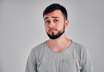 Young man in the studio on a gray background