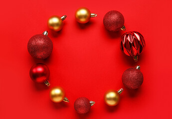 Frame made of Christmas balls on red background