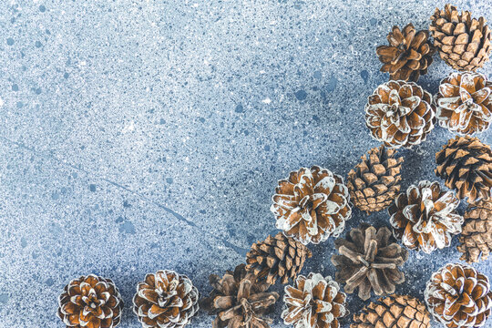 Christmas or New Year background with pine cones on gray background. Winter concept, top view