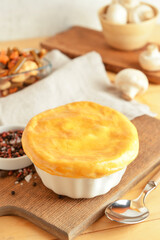 Board with tasty vegetable pot pie on wooden background