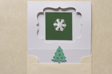 die cut paper card with fancy window opening and fabric snowflake and christmas tree