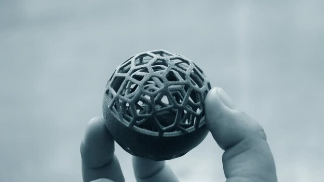 Man holding plastic model printed on powder 3d printer from polyamide powder.