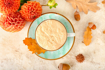 Beautiful autumn composition with cup of coffee, chrysanthemum flowers and leaves on light background