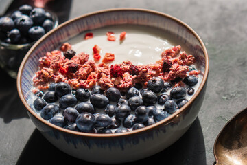 Berry mix bowl super food with healthy granola grain muesli in yogurt for breakfast food meal with honey blueberry strawberry