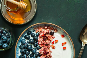 Berry mix bowl super food with healthy granola grain muesli in yogurt for breakfast food meal with honey blueberry strawberry