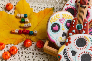 Fototapeta premium Tasty cookies for Mexico's Day of the Dead (El Dia de Muertos) and fallen leaf on tray, closeup