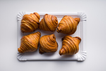 top view tray of croissants on white background