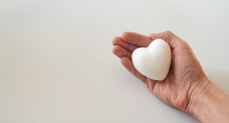 boy holding white heart in palm. Organ donation and insurance concept. World heart health concept. World organ donation day. Concept of healthy heart for healthy life. selective focus