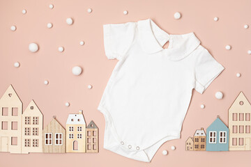 Mockup of white infant bodysuit made of organic cotton with eco friendly baby toys. Onesie template for brand, logo, advertising. Flat lay, top view