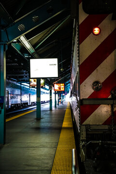 artistic photo of train station with train awaiting to depart