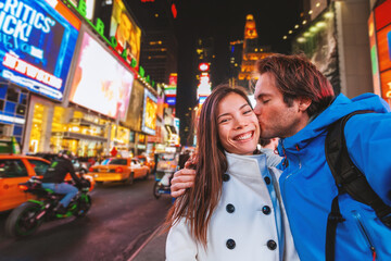 Selfie photo with phone by interracial couple tourists walking at Times Square in New York City on...