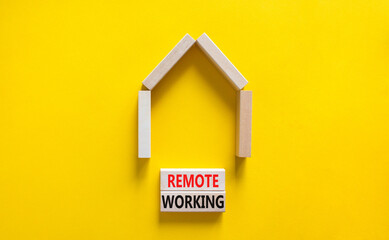 Fototapeta na wymiar Remote working symbol. Concept words 'Remote working' on wooden blocks near miniature wooden house. Beautiful yellow background. Business, remote working concept.