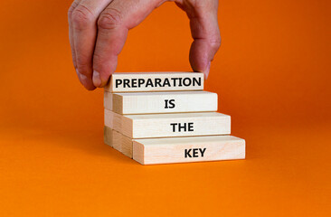 Preparation is the key symbol. Wooden bloks with words 'Preparation is the key'. Businessman hand....