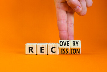 Recovery and recession symbol. Businessman turns cubes and changes the word 'recession' to 'recovery'. Beautiful orange table, orange background. Business and recovery - recession concept. Copy space.
