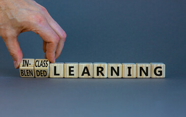 Blended or in-class learning symbol. Businessman turns cubes, changes words blended learning to...