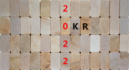OKR, objectives and key results symbol. Wooden blocks with words 'OKR 2022' on beautiful wooden background. Business, OKR 2022, objectives and key results concept. Copy space.