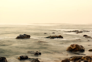 Fototapeta na wymiar Long Exposure Foam Sea view with rocks