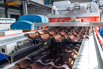 Process of forming Metal Tile close up in metalforming machine.