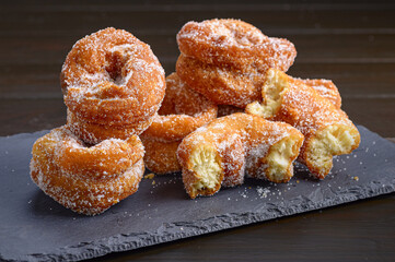 Serving of crispy Spanish donuts - rosquillas on a black board